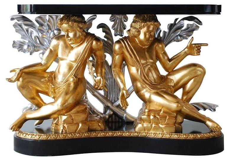 Decorative table with gilded angel figures on a black base