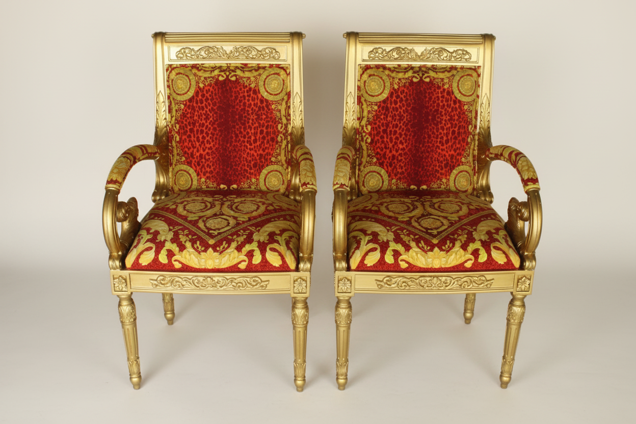 Full front-facing hero shot of the Pair of Luxury Custom Vanitas Armchairs with Gold Leaf finish and Versace Barocco Leopard Red velvet against a clean soft luxury background