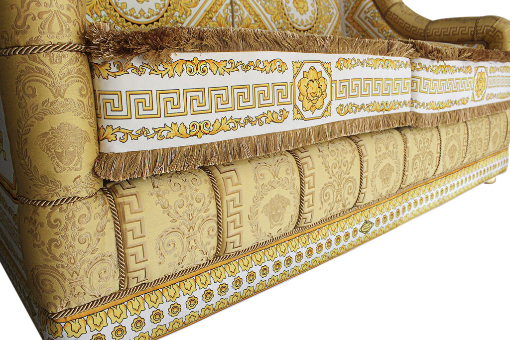 A GIANNI VERSACE FABRIC UPHOLSTERED CARVED GILTWOOD SOFA