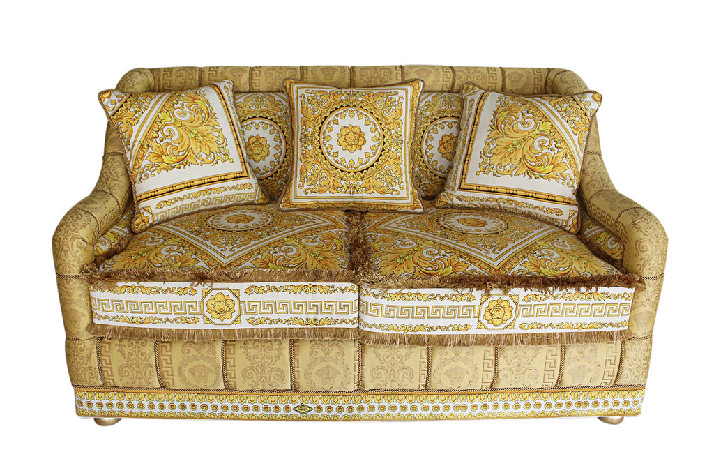 A GIANNI VERSACE FABRIC UPHOLSTERED CARVED GILTWOOD SOFA