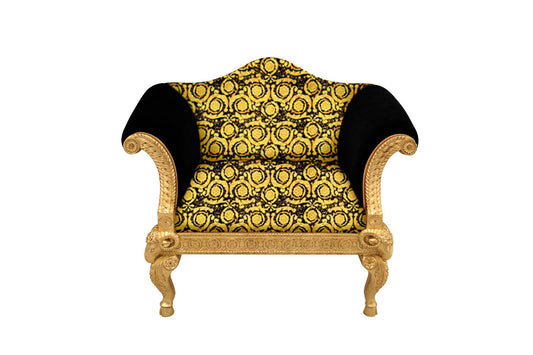 A single-seater sofa with a gold leaf finish and a Versace vanity barocco pattern in black and gold.